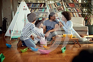 A young family enjoying food and play at home together. Family, home, together, playtime photo