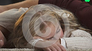 Young family falling asleep under x-mas tree waiting for Santa Claus, magic time