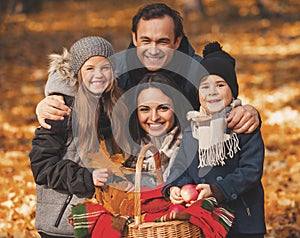 Young Family of Four Have Fun in Autumn Park.