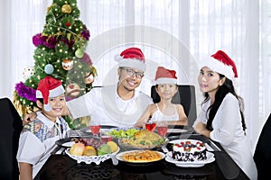 Young family having Christmas dinner at home