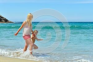 Young family having fun on the beach