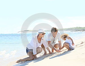 Young family having fun on the beach