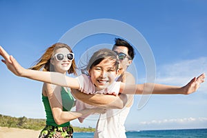 young Family Having Fun at the Beach