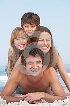 Young Family Having Fun On Beach Holiday