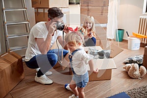 Young family having fun while unpacking boxes in new apartment. new apartment, new beginning,  concept