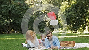 Young family having picnic outdoors