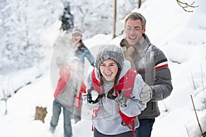 Young Family Having Snowball Fight