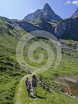 Young family hiking around Bannalp in Switzerland