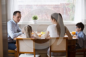 Young family with kids enjoy healthy breakfast at home