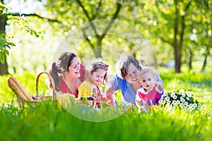 Young family with kids having picnic outdoors