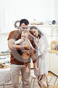 Young family with little cute son on kitchen in morning happy smiling, lifestyle people concept