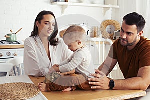 Young family with little cute son on kitchen in morning happy smiling, lifestyle people concept