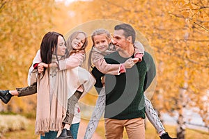 Portrait of happy family of four in autumn day