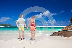 Young family in love having fun at tropical Baie Lazare beach. Mahe, Seychelles