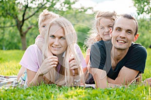 Young family lying on grass in countryside