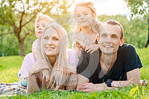 Young family lying on grass in countryside