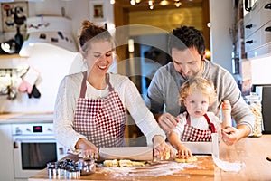 Young family making cookies at home.