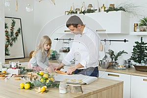 Young family making cookies at home. food, family, christmas, hapiness and people concept - smiling family making a