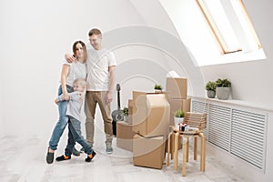 Young family, man woman and child son in new apartments. Boxes with cargo on a white background.