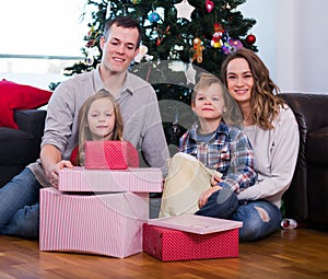 Young family members presenting gifts on Christmas
