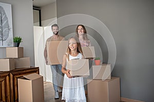 Young family moving into new house with cardboards