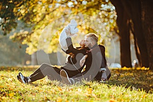 Young family and newborn son in autumn park