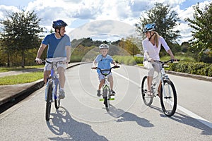 Young Family Parents and Boy Son Cycling