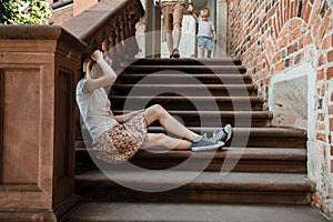 Young family. Parents sit with their son on the stairs. Mom and dad and your baby. Little boy.