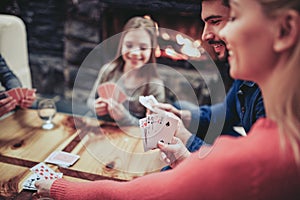 Young family playing card game