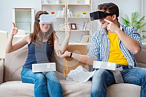 The young family playing games with virtual reality glasses