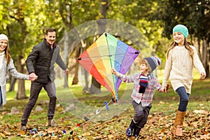 Young family playing with a kite