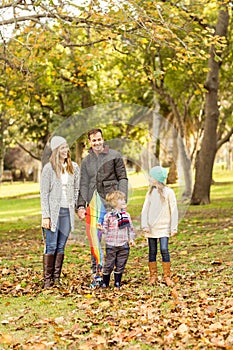 Young family playing with a kite