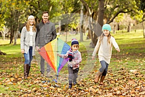 Young family playing with a kite