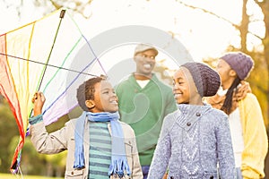 Young family playing with a kite