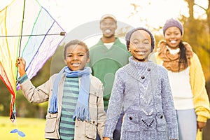 Young family playing with a kite