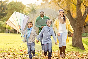 Young family playing with a kite