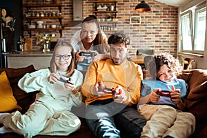 Young family playing video games together in the living room on a gaming console