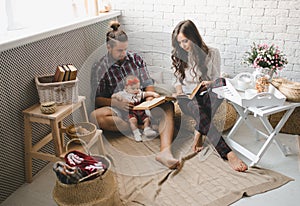 Young family reading story indoors