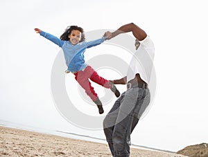 Young Family Relaxing On Beach Camping Holiday