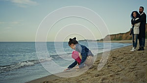 Young family relaxing vacation together at sea beach outdoors. Holiday concept.