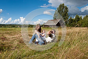 Young family resting in a field