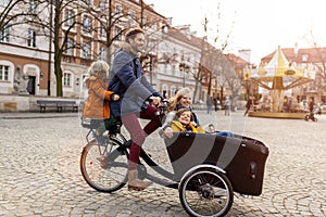 Young family riding in a cargo bicycle