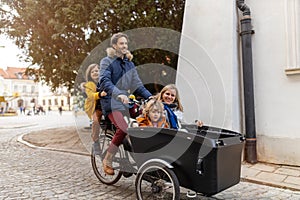 Young family riding in a cargo bicycle