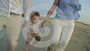 Young Family Running on the Beach