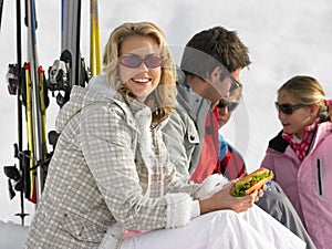 Young Family Sharing A Picnic On Ski Vacation