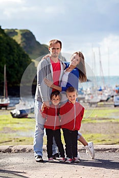 Young family with small kids on a harbor in the afternoon