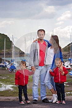 Young family with small kids on a harbor in the afternoon