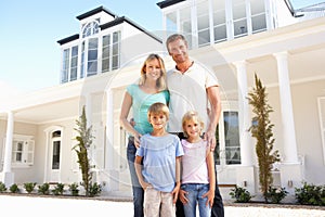 Young Family Standing Outside Dream Home photo