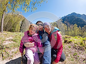 Young family taking a selfie in spring forest on a sunny day.