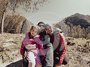 Young family taking a selfie in spring forest on a sunny day.